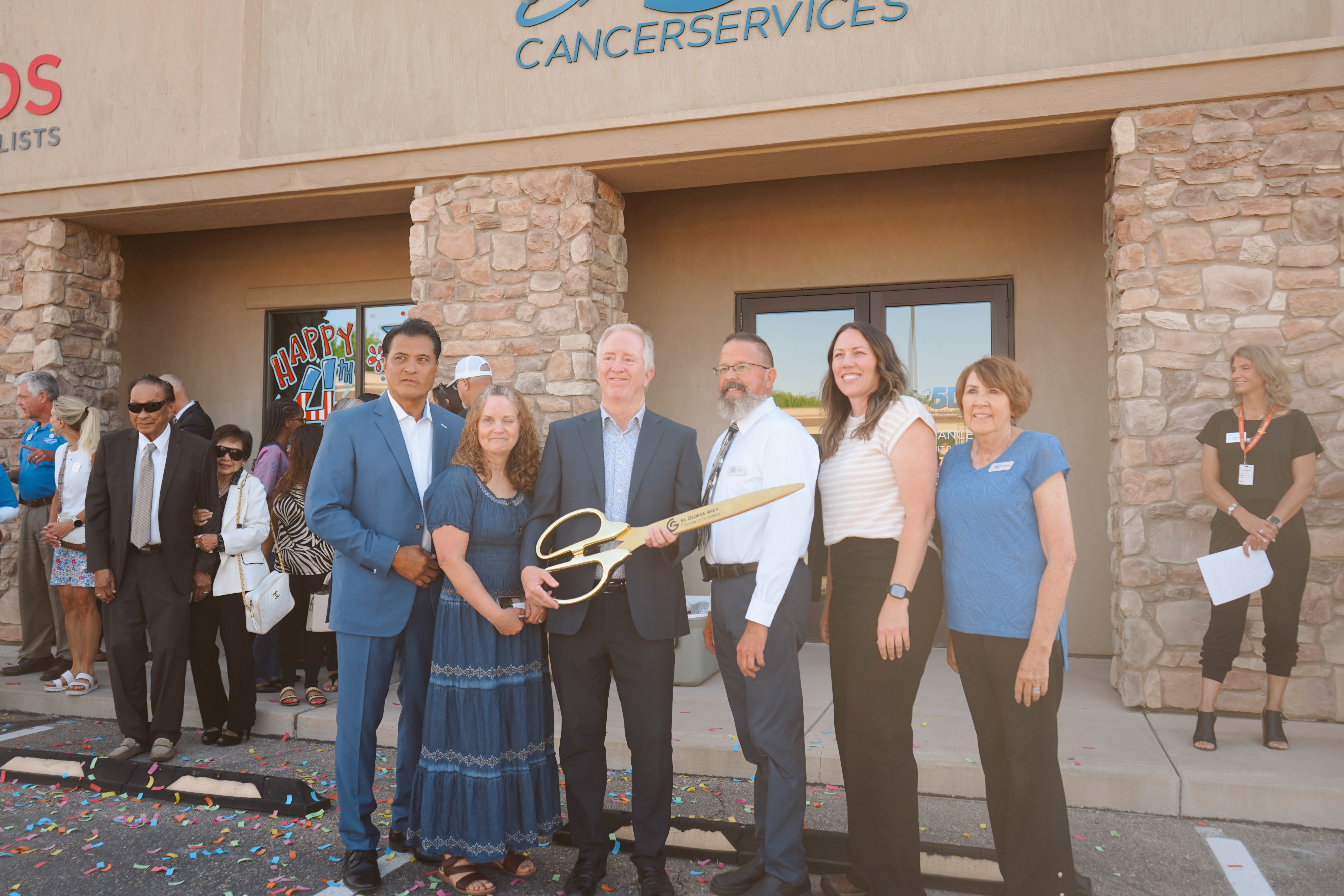 5D Cancer Services ribbon cutting ceremony with scissors at grand opening