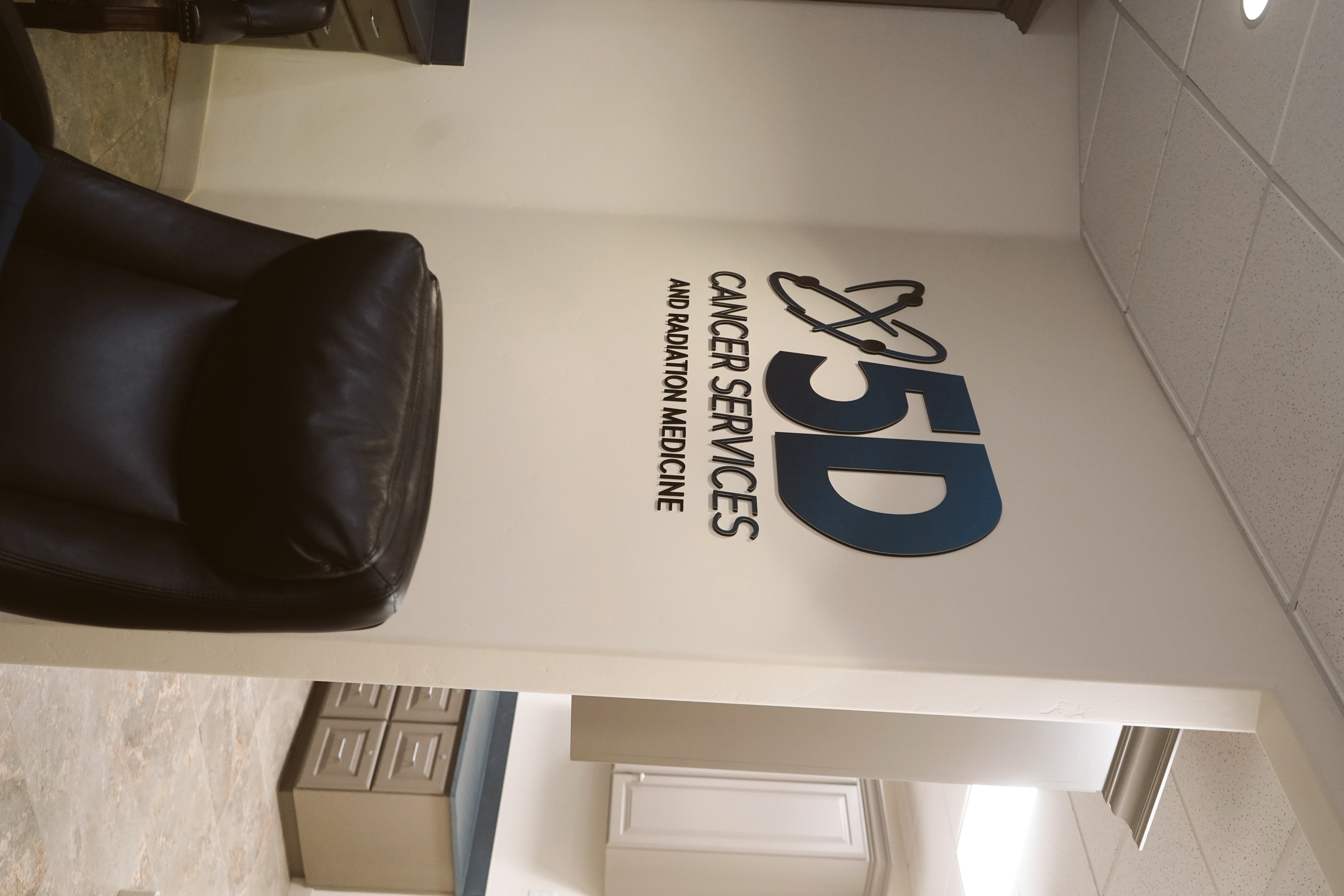 5D Cancer Services reception area with 5D Cancer Services and Radiation Medicine signage